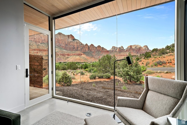 112 Canyon Cv, Springdale, UT 84767 - entryway featuring baseboards, concrete flooring, a wall of windows, and a mountain view