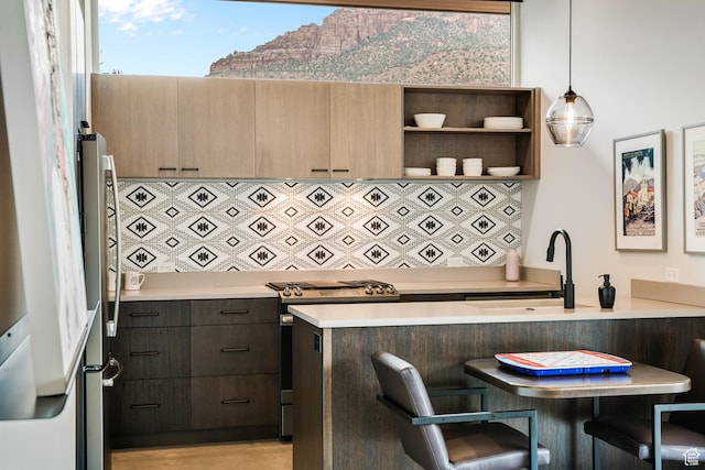 112 Canyon Cv, Springdale, UT 84767 - kitchen with a sink, a kitchen breakfast bar, light countertops, and gas stove
