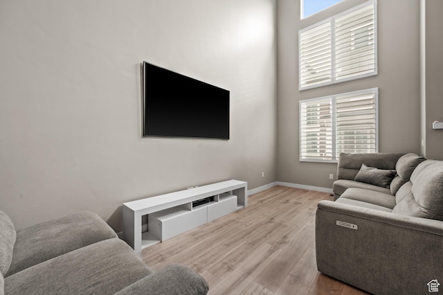 15084 S Wild Horse Way, Bluffdale, UT 84065 - living room featuring wood finished floors, a healthy amount of sunlight, and baseboards