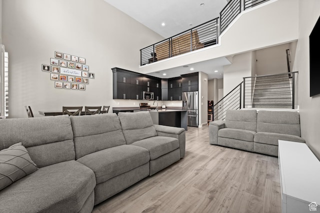15084 S Wild Horse Way, Bluffdale, UT 84065 - living room with a towering ceiling, stairs, recessed lighting, and light wood-type flooring