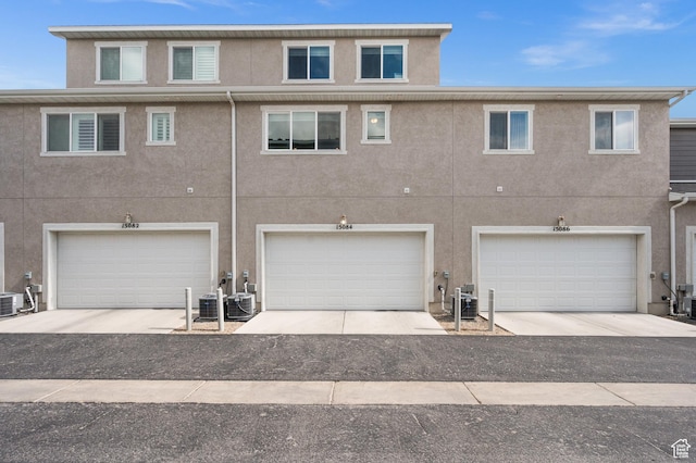 15084 S Wild Horse Way, Bluffdale, UT 84065 - view of front of home featuring stucco siding, central AC, and an attached garage