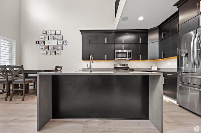 15084 S Wild Horse Way, Bluffdale, UT 84065 - kitchen featuring recessed lighting, a high ceiling, a sink, stainless steel appliances, and dark cabinetry