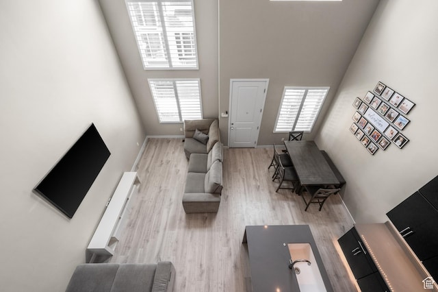 15084 S Wild Horse Way, Bluffdale, UT 84065 - living area featuring a towering ceiling, wood finished floors, and baseboards