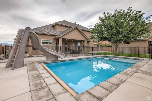 595 W 2050 S, Hurricane, UT 84737 - view of swimming pool with a patio area, a fenced in pool, an in ground hot tub, a water slide, and fence