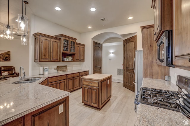 595 W 2050 S, Hurricane, UT 84737 - kitchen with a sink, visible vents, freestanding refrigerator, arched walkways, and gas stove