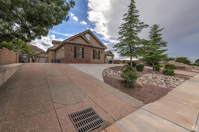 595 W 2050 S, Hurricane, UT 84737 - view of front of home with fence, central AC, stucco siding, and brick siding