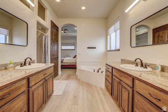 595 W 2050 S, Hurricane, UT 84737 - full bath featuring wood finished floors, a shower with curtain, a bath, and a sink
