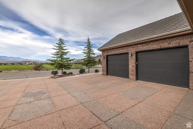 595 W 2050 S, Hurricane, UT 84737 - exterior space with a mountain view, a garage, and brick siding