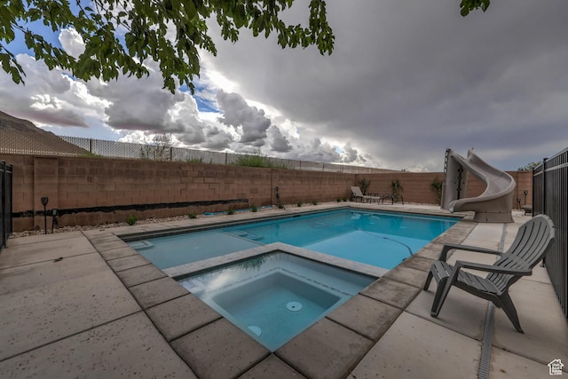 595 W 2050 S, Hurricane, UT 84737 - view of pool featuring a fenced backyard, a fenced in pool, a water slide, a patio, and an in ground hot tub