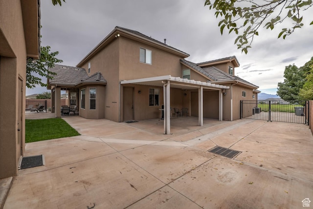 595 W 2050 S, Hurricane, UT 84737 - back of property featuring a tile roof, fence, stucco siding, and a patio area