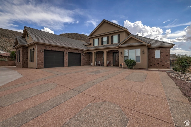595 W 2050 S, Hurricane, UT 84737 - view of front of house featuring a garage, brick siding, fence, and concrete driveway