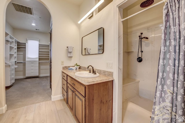 595 W 2050 S, Hurricane, UT 84737 - full bathroom featuring curtained shower, visible vents, baseboards, wood finished floors, and vanity