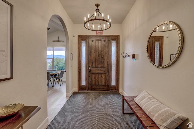595 W 2050 S, Hurricane, UT 84737 - entrance foyer with arched walkways, an inviting chandelier, vaulted ceiling, and baseboards