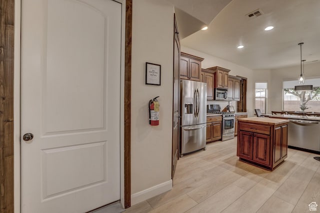 595 W 2050 S, Hurricane, UT 84737 - kitchen with light wood-style flooring, decorative light fixtures, appliances with stainless steel finishes, a center island, and visible vents