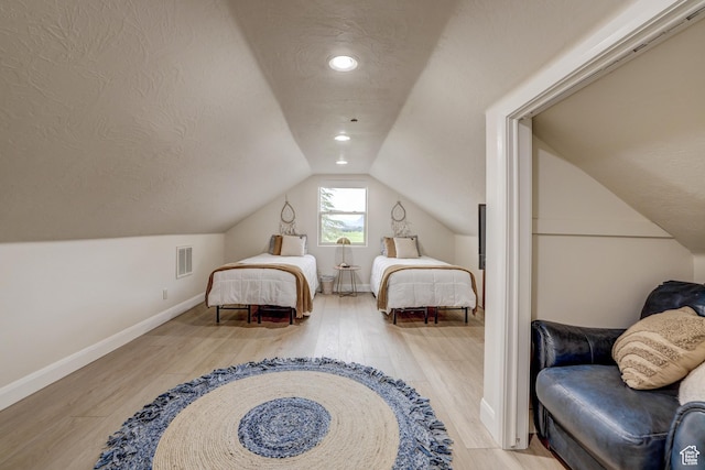 595 W 2050 S, Hurricane, UT 84737 - bedroom featuring wood finished floors, visible vents, baseboards, a textured ceiling, and lofted ceiling
