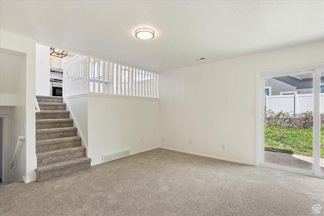 42 W 1980 S, Clearfield, UT 84015 - unfurnished living room with baseboards, visible vents, a notable chandelier, and carpet