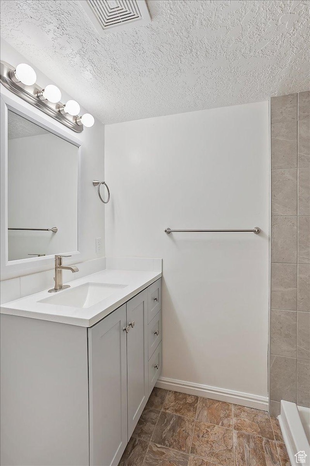 42 W 1980 S, Clearfield, UT 84015 - bathroom featuring baseboards, visible vents, a textured ceiling, and vanity
