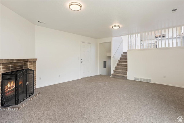 42 W 1980 S, Clearfield, UT 84015 - unfurnished living room featuring visible vents, a fireplace, carpet, and stairway