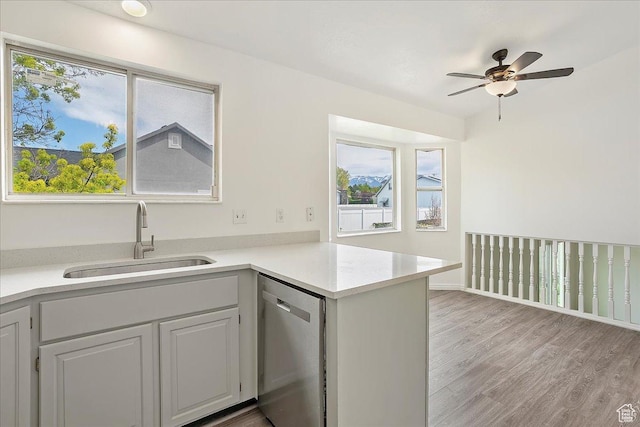 42 W 1980 S, Clearfield, UT 84015 - kitchen featuring stainless steel dishwasher, a sink, ceiling fan, light countertops, and light wood finished floors