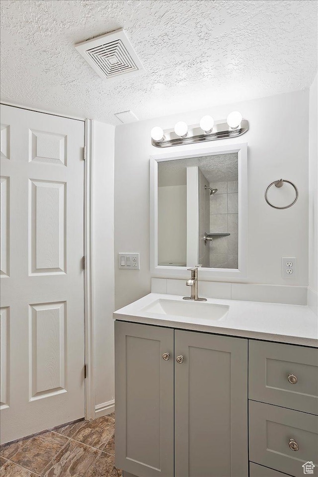 42 W 1980 S, Clearfield, UT 84015 - bathroom featuring visible vents, a textured ceiling, and vanity