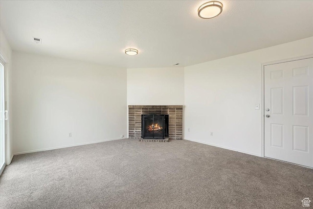 42 W 1980 S, Clearfield, UT 84015 - unfurnished living room with a brick fireplace, visible vents, carpet, and baseboards