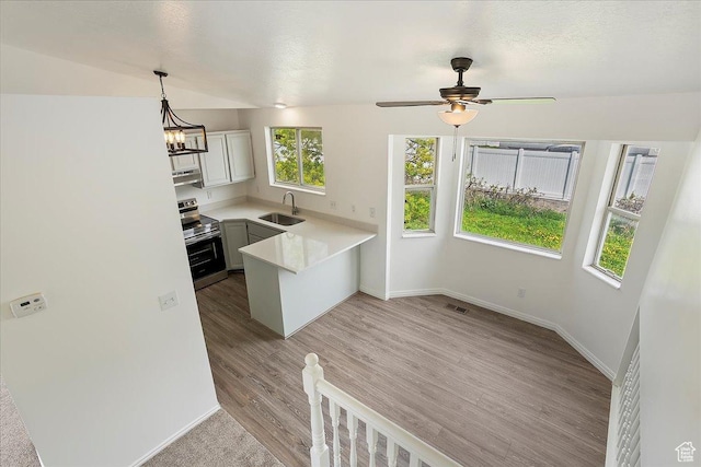 42 W 1980 S, Clearfield, UT 84015 - kitchen featuring stainless steel range with electric cooktop, light countertops, a sink, baseboards, and a peninsula