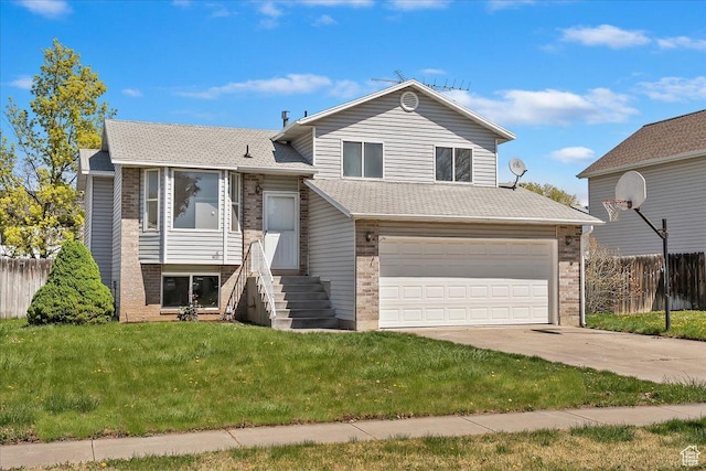split level home with driveway, a front yard, fence, brick siding, and a garage