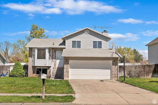 42 W 1980 S, Clearfield, UT 84015 - tri-level home with a garage, brick siding, fence, and a front lawn