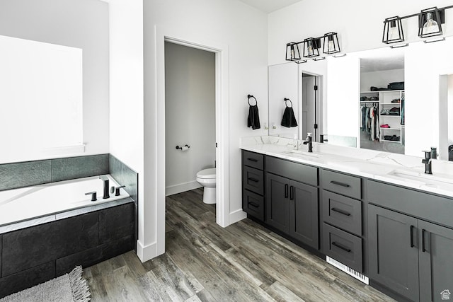 166 W 580 N, Redmond, UT 84652 - bathroom with toilet, double vanity, a sink, and wood finished floors