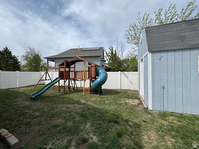 1614 W Eisenhower Way, Salt Lake City, UT 84104 - view of jungle gym featuring an outdoor structure, a storage shed, a fenced backyard, and a lawn