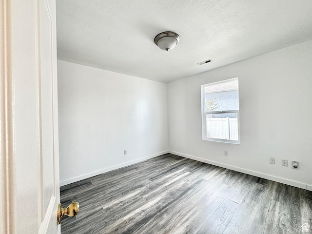 1614 W Eisenhower Way, Salt Lake City, UT 84104 - unfurnished room with dark wood finished floors, baseboards, visible vents, and a textured ceiling