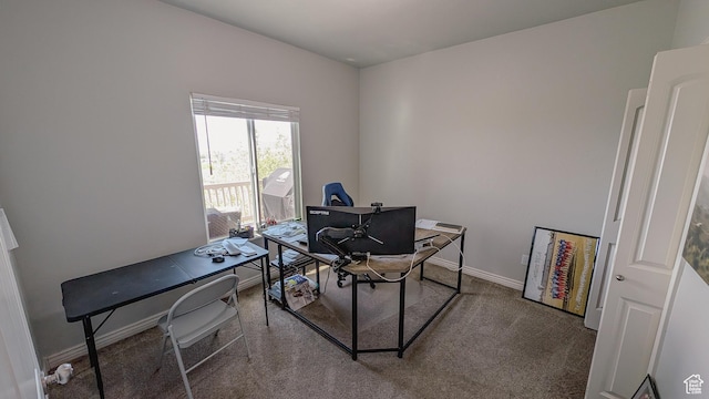 carpeted home office featuring baseboards