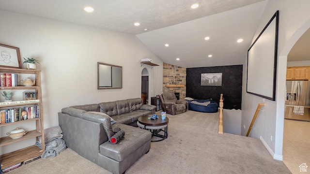 carpeted living area featuring baseboards, recessed lighting, arched walkways, and vaulted ceiling