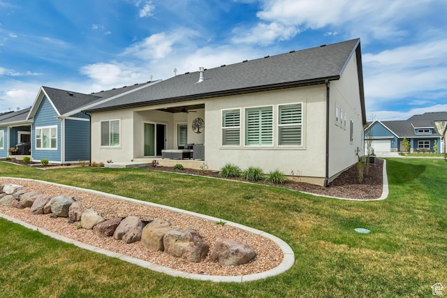 back of property featuring a patio area, a shingled roof, ceiling fan, stucco siding, and a yard