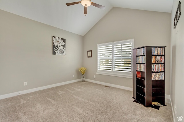 carpeted empty room with a ceiling fan, high vaulted ceiling, visible vents, and baseboards