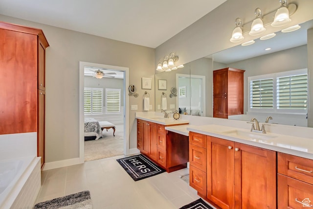 bathroom featuring double vanity, ceiling fan, ensuite bathroom, a sink, and tiled tub