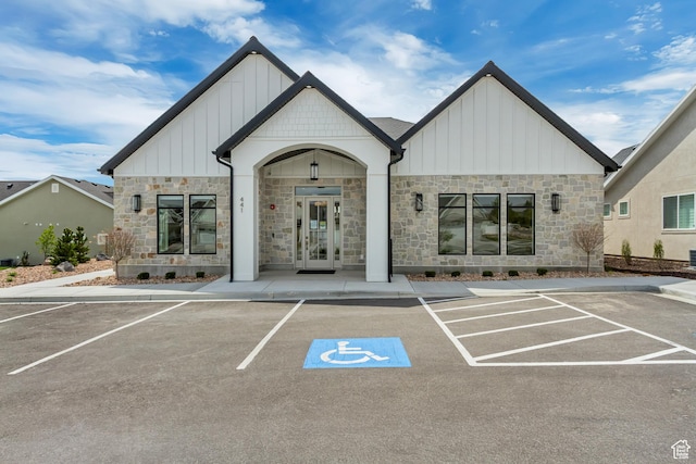 view of building exterior with uncovered parking