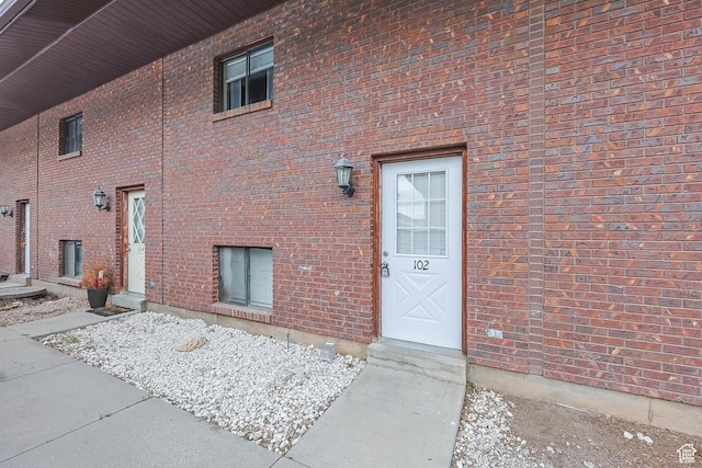 property entrance featuring brick siding