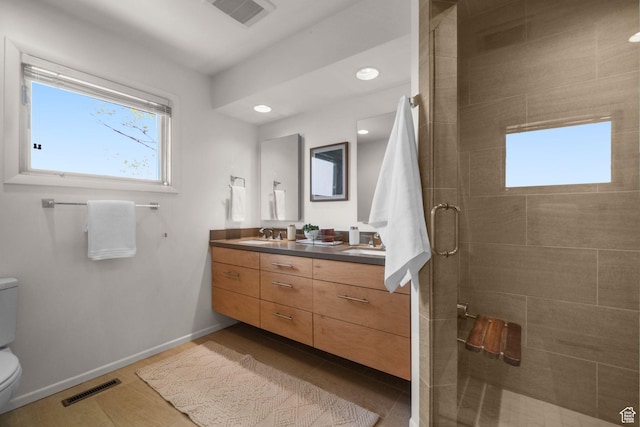 813 N Northview Dr E, Salt Lake City, UT 84103 - full bathroom featuring visible vents, a sink, toilet, and a tile shower