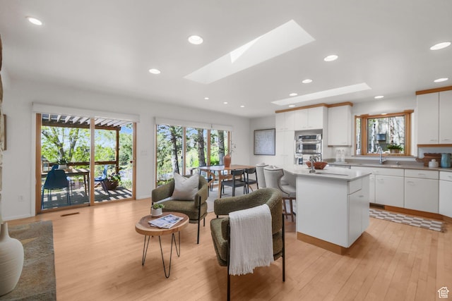 813 N Northview Dr E, Salt Lake City, UT 84103 - living room with recessed lighting, a skylight, and light wood-style floors