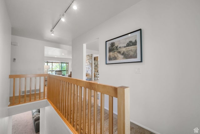 813 N Northview Dr E, Salt Lake City, UT 84103 - hall featuring an upstairs landing, rail lighting, and carpet