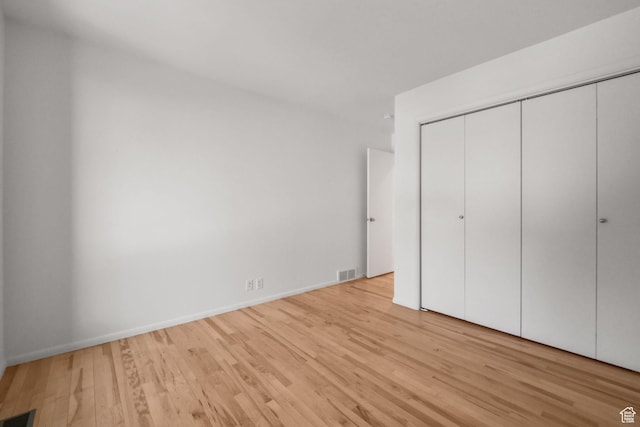 813 N Northview Dr E, Salt Lake City, UT 84103 - unfurnished bedroom with wood finished floors, visible vents, baseboards, and a closet