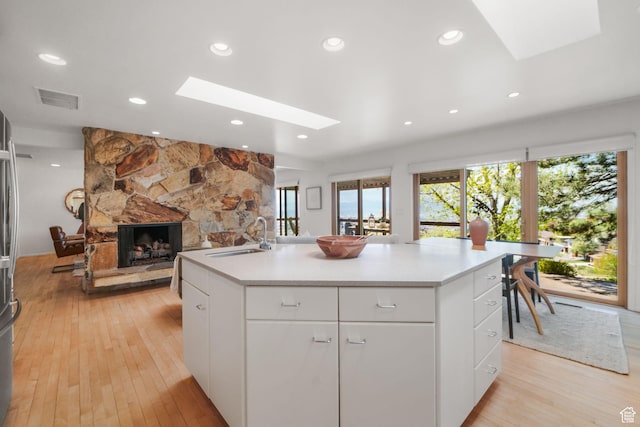 813 N Northview Dr E, Salt Lake City, UT 84103 - kitchen featuring a skylight, a sink, visible vents, and plenty of natural light