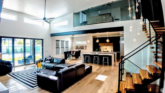 13327 S Bullitt Ln, Draper, UT 84020 - living room with a towering ceiling, a ceiling fan, stairway, and light wood-type flooring
