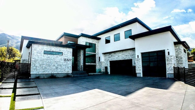 13327 S Bullitt Ln, Draper, UT 84020 - contemporary house featuring fence, stucco siding, concrete driveway, and stone siding