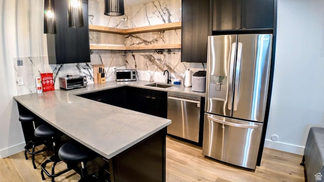 13327 S Bullitt Ln, Draper, UT 84020 - kitchen featuring a sink, stainless steel appliances, a kitchen bar, open shelves, and light countertops