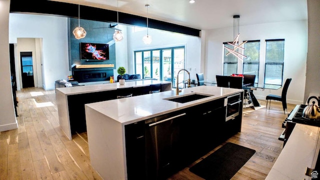 13327 S Bullitt Ln, Draper, UT 84020 - kitchen with open floor plan, an island with sink, dark cabinetry, and a sink
