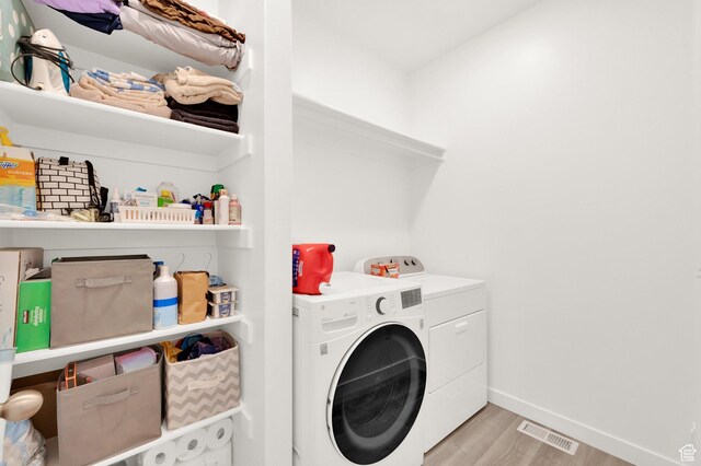 1131 S Red Cliff Dr, Santaquin, UT 84655 - laundry area with laundry area, visible vents, washing machine and dryer, light wood-type flooring, and baseboards