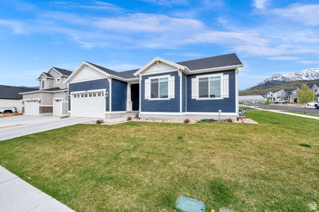 1131 S Red Cliff Dr, Santaquin, UT 84655 - view of front of property featuring a garage, a front lawn, a mountain view, and driveway