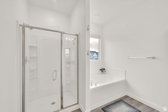 1131 S Red Cliff Dr, Santaquin, UT 84655 - bathroom with baseboards, wood finished floors, a garden tub, and a stall shower